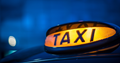Close up of the taxi sign on top of a cab