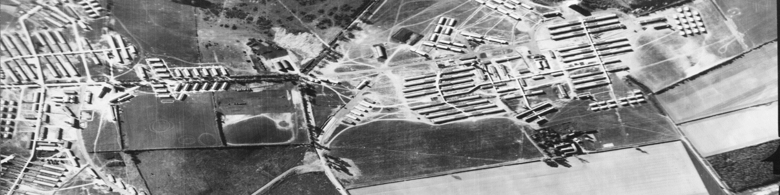 black and white ariel image of many small buildings in countryside