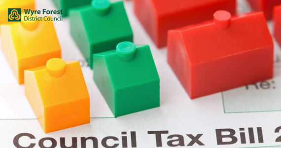 Plastic houses in yellow, green and red on a Council Tax Bill 