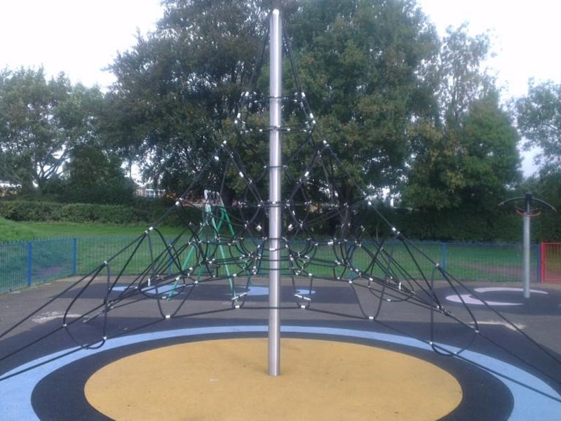 A climbing net within the children's play area and painted soft surface floor covering.