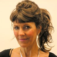 headshot of woman with tied up long brown hair
