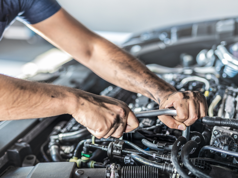 A mechanic working on a car