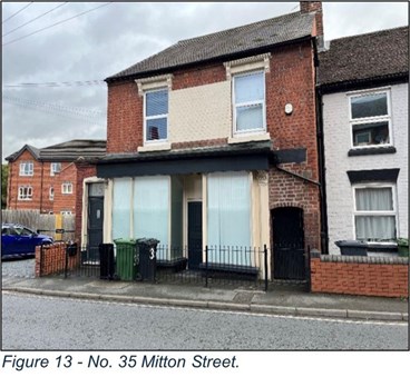 former shop front of brick building now blanked off