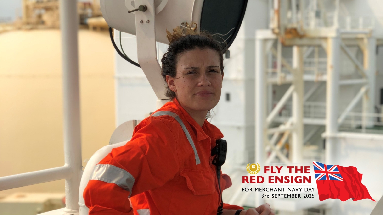 Woman in a red jumpsuit. Wording says Fly the Red Ensign, Merchant Navy Day, 3rd September