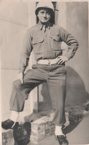 sepia photo of man in military uniform smiling at camera